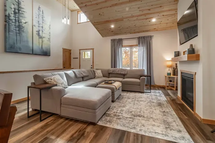 A stylish living room featuring a comfortable gray couch set against crisp white walls, creating a clean and modern space to relax.
