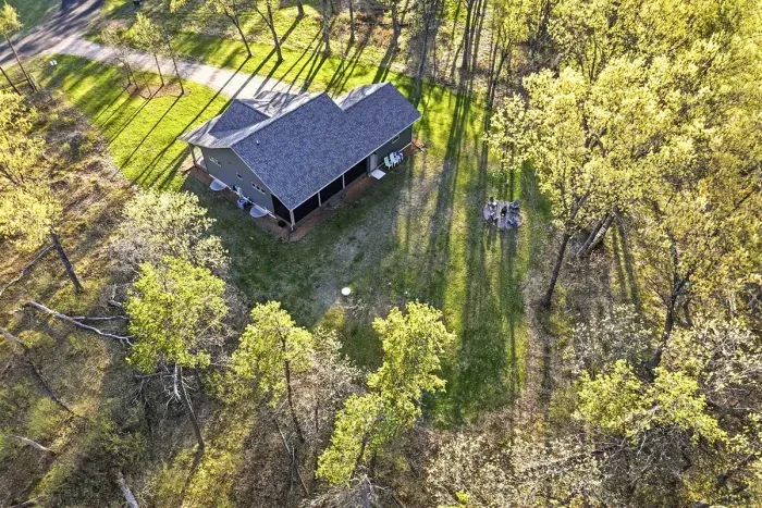 Serene wooded retreat offering privacy, generous outdoor space, and a warm, inviting home setting.