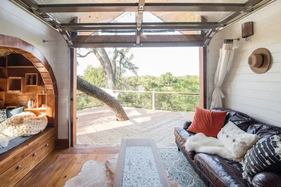 Glass overhead door from living room onto upper deck.