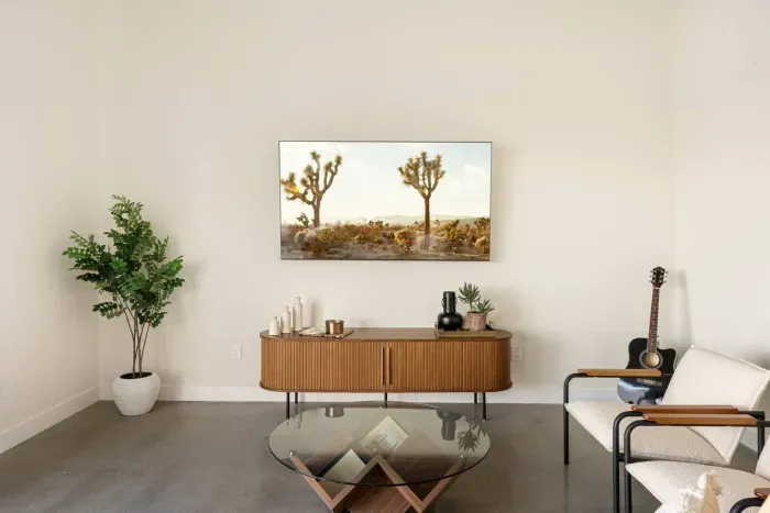 4️⃣ Living Room with Joshua Tree Artwork
 Minimalist calm with desert soul. Lounge in a sun-lit living space framed by Joshua Tree views—modern design meets desert serenity.
