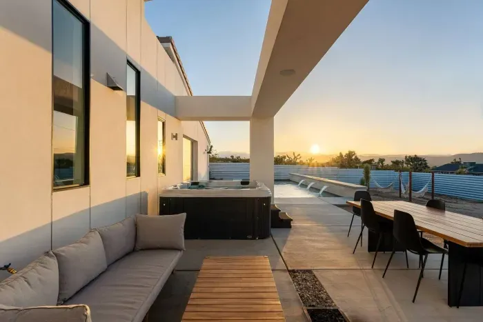 Unwind in the hot tub as the desert sun melts into the horizon — golden hour is pure magic here.