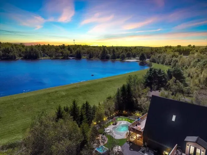 Scenic Retreat: Enjoy stunning lake views and unwind in the hot tub under vibrant skies!