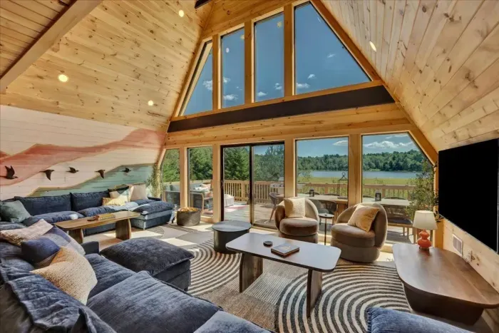 Living Room: Spacious,  stunning lake views and two comfortable couches seating for large gatherings