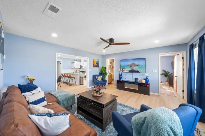 Living Room: A cozy fireplace sets the scene for evenings filled with comfort and coastal charm.