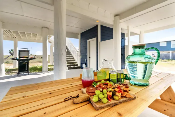 Share laughter, meals, and memories at the picnic table beneath the house, with the Gulf breeze close by.