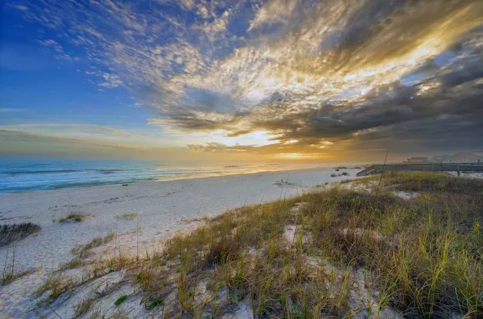 Fort Morgan at dusk with soft waves, fading light, and a peaceful shoreline as the day gently winds down.