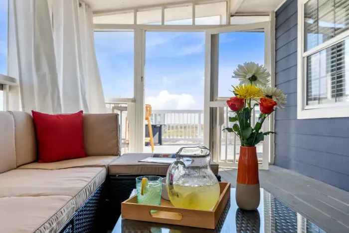 On the screened porch, time slows down — lemonade in hand, book by your side, and Gulf waves whispering beyond the dunes.