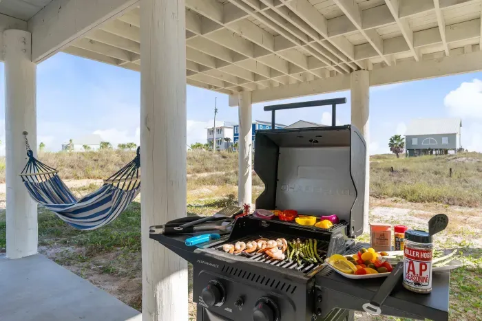 Gather under the house where hammocks invite you to relax and the grill is ready for fresh Gulf Coast shrimp.