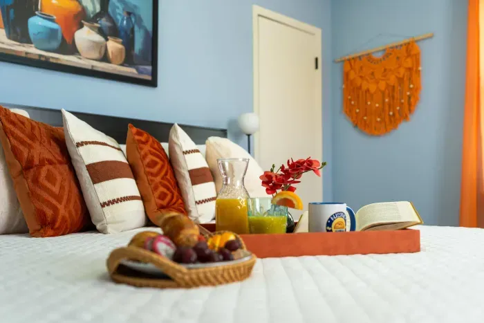 First Guest Bedroom: A king bed surrounded by the warmth of sunrise tones.