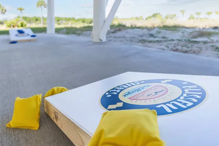 Bring out your competitive side with cornhole, Connect Four, and ring toss in the shaded game area beneath the house.