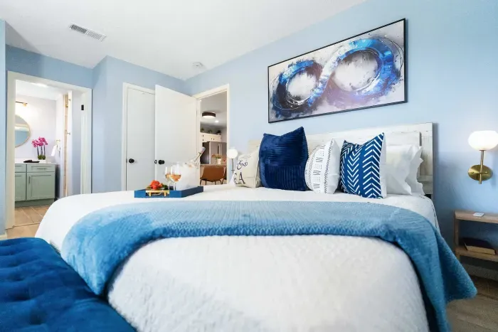 Primary Bedroom: Your private retreat with a king bed dressed in plush bedding, a seating area for quiet moments, and an en-suite bath for added comfort.