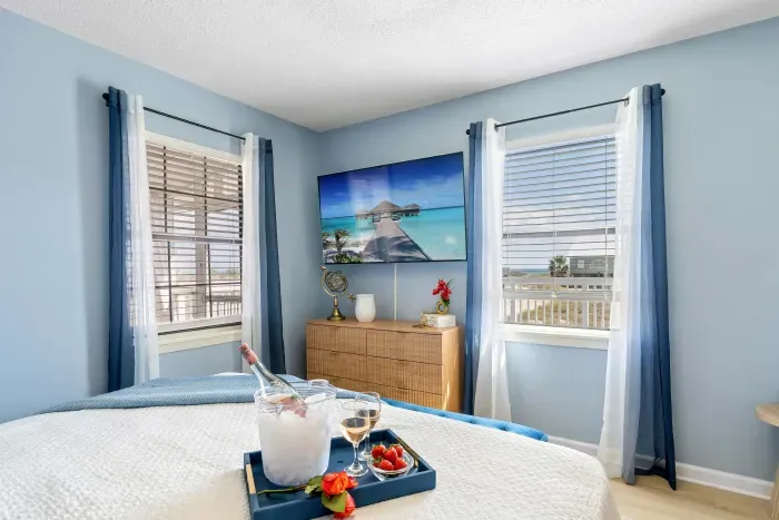 Primary Bedroom: Rest easy in a king-size bed while gazing out to the Gulf waters, where salty breezes and the quiet rustle of dune grass set the scene.