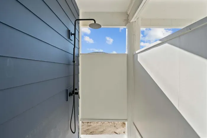 Outdoor Shower: The perfect spot to rinse off sandy toes after a day on the beach.