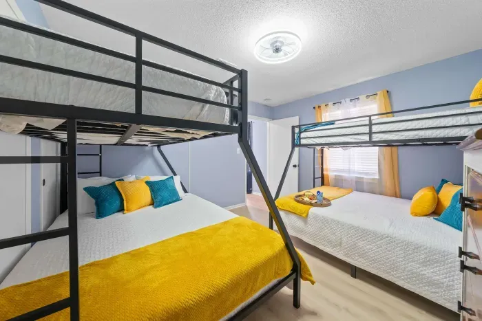 Second Guest Bedroom: With two queen-over-twin bunk beds, this room is perfect for families or friends. A cozy space for rest and fun-filled game nights.