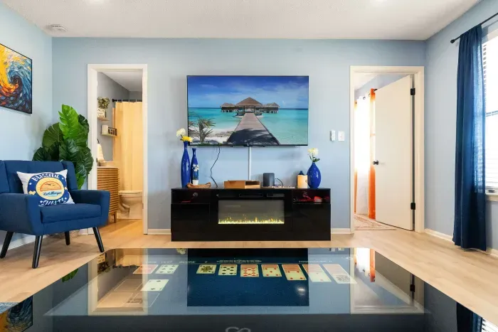 Living Room: Curl up by the fireplace after a day on the shore. The living room is your perfect retreat for warmth and relaxation.