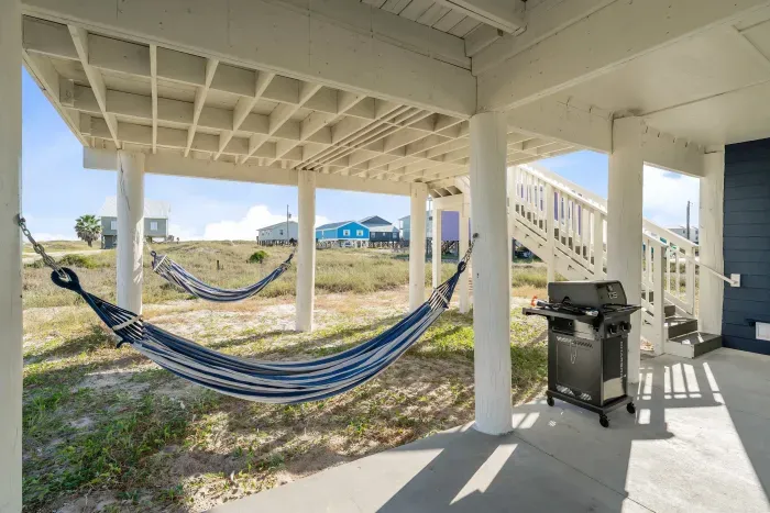 Swing the day away! Hammocks over soft sand create the perfect shady retreat beneath the house.