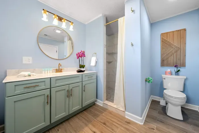 Primary Bathroom: The primary bathroom blends coastal style with modern convenience.