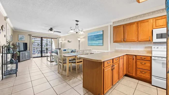 Kitchen overlooks dining and living room areas