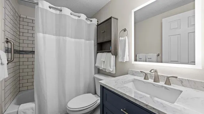 Full bathroom features shower / tub combo 