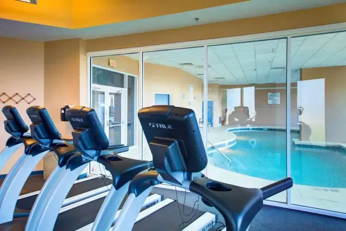 Gym looking into indoor pool
