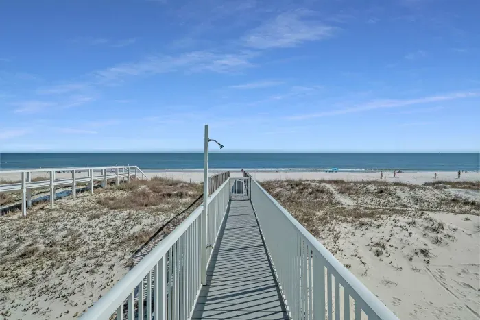 Private boardwalk to the beach with shower