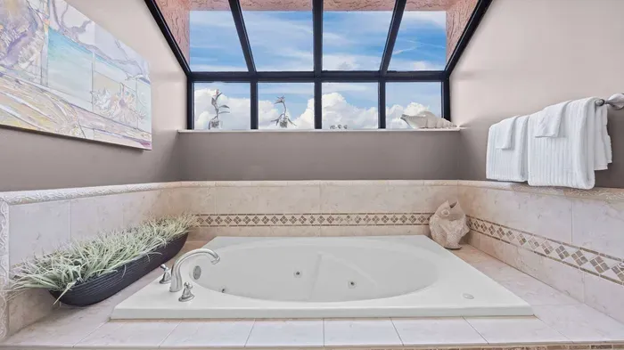 Large garden tub with vaulted windows