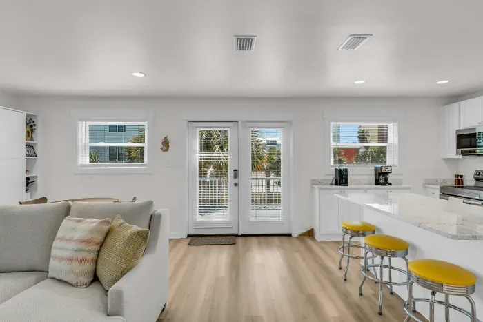 Living room and kitchen opens up to balcony