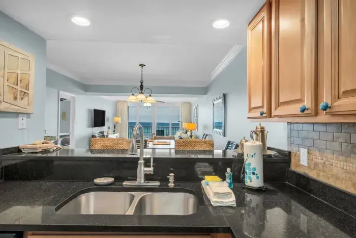 Open concept kitchen overlooks dining and living room area