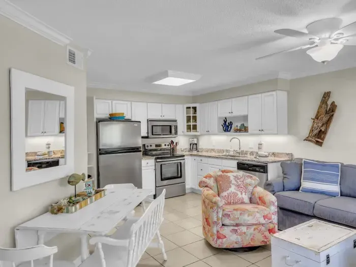 Open concept kitchen and living with dining seating for 4