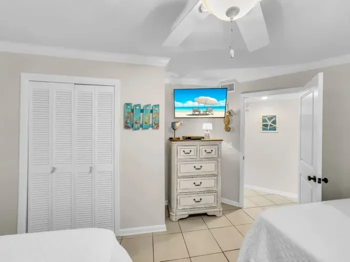 Guest bedroom with two queen beds view of TV