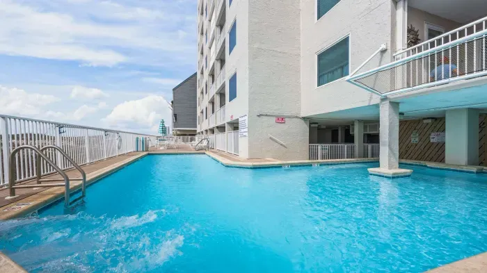 Outdoor pool with covered section and water feature