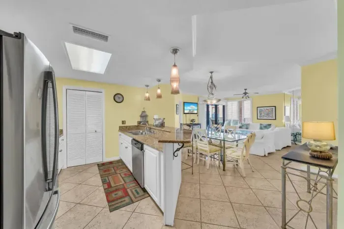 Open concept kitchen overlooks dining and living room area