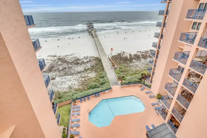 Balcony overlooks the pool and the fishing pier