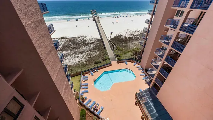Balcony has view of pool, Gulf, and pier