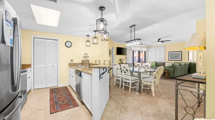 Open concept kitchen overlooks dining and living room area