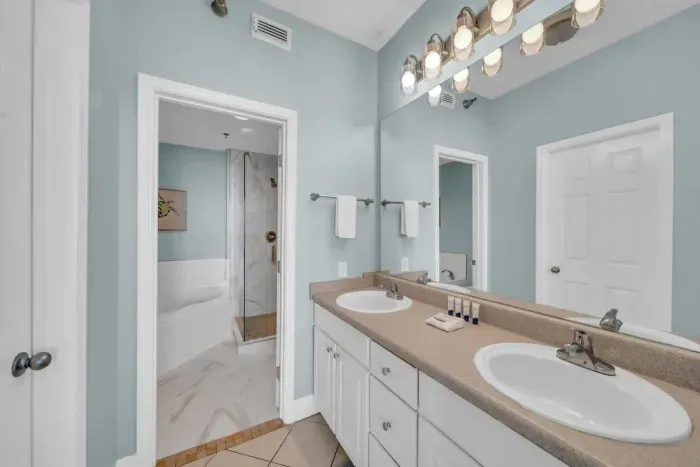 This Primary Bedroom features a private bathroom with a Jacuzzi Tub and a separate Glass Shower.