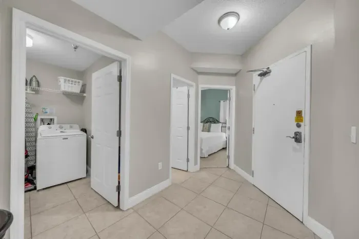 Hallway View of Laundry Room and 1st Guest Bedroom