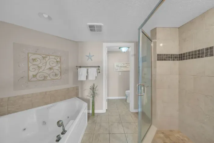 Primary bathroom has walk-in shower and jetted tub