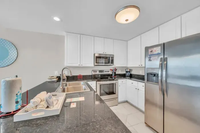 The fully stocked kitchen with stainless steel appliances