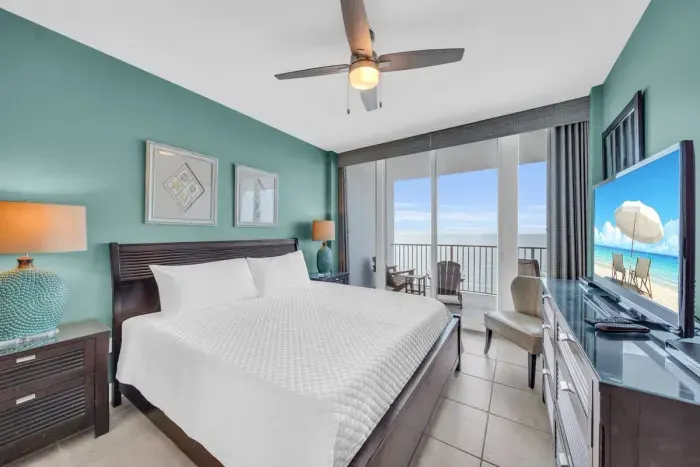 Primary Bedroom with a King bed, floor-to-ceiling sliding glass doors