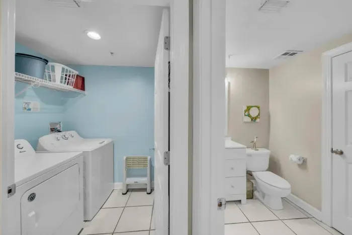 Washer and dryer and guest bathroom view from hallway