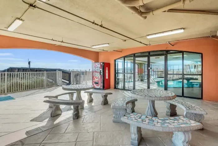 Covered patio area off indoor pool