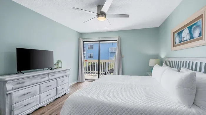 Primary bedroom with balcony access