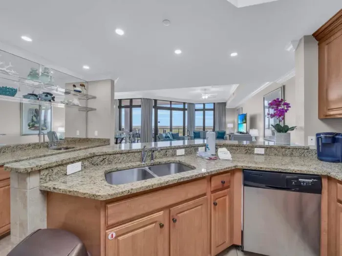Fully equipped kitchen overlooks living room