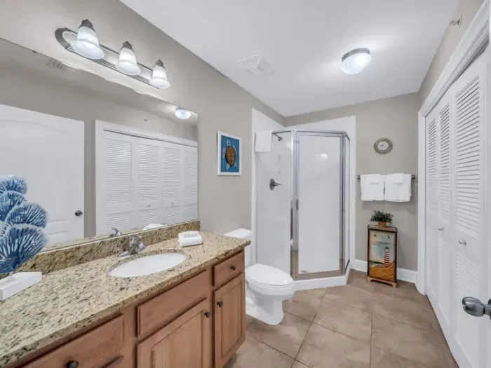 Hallway guest bathroom with in unit laundry