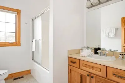 Bathroom Oasis: Bright, spacious retreat featuring elegant fixtures and nature views!