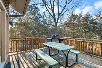Deck Delight: Savor meals al fresco on the spacious deck surrounded by serene woods!