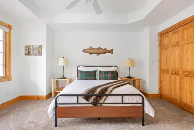 Bedroom Retreat: Enjoy peaceful mornings beside rustic charm and woodsy decor in this inviting room!
