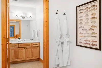 Bathroom Bliss: Stunning wooden accents and plush robes await for your ultimate relaxation!