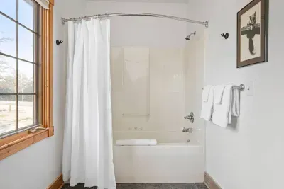 Main Level Bathroom Oasis: Unwind with modern fixtures and natural light for a refreshing retreat!